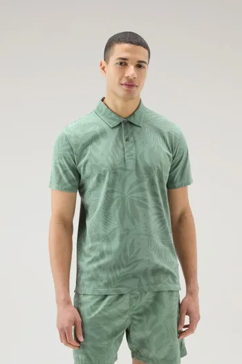 Polo tinta in capo in cotone elasticizzato con stampa tropical                                                                  