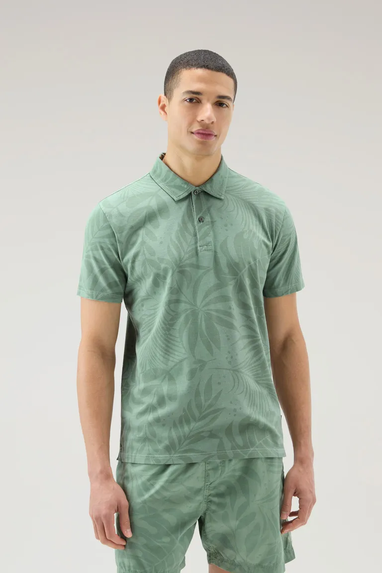Polo tinta in capo in cotone elasticizzato con stampa tropical                                                                  