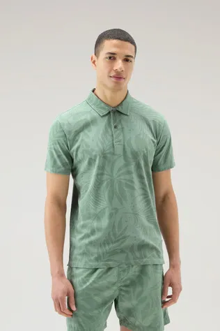 Polo tinta in capo in cotone elasticizzato con stampa tropical                                                                  