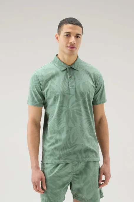 Polo tinta in capo in cotone elasticizzato con stampa tropical                                                                  
