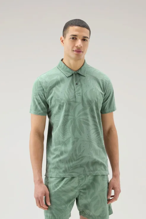 Polo tinta in capo in cotone elasticizzato con stampa tropical                                                                  